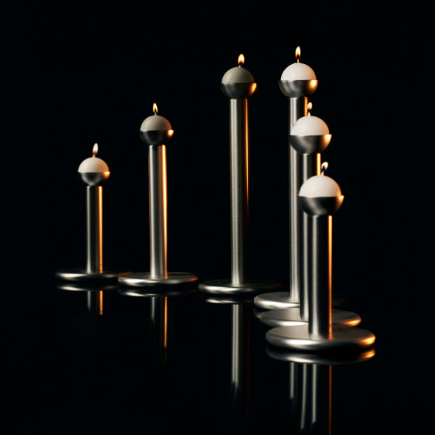 The Pipe candleholders, designed by Magnus Löfgren, are available in silver and brass finishes.